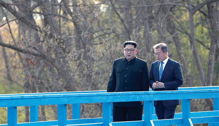 President Moon Jae-in and Chairman Kim Jong Un walking along a footbridge at the border village of Panmunjeom
