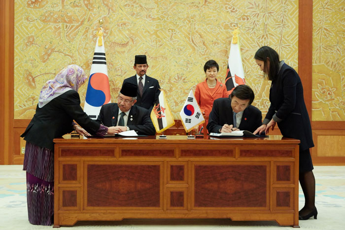 박근혜 대통령과 하사날 볼키아 국왕이 참석한 가운데 한국과 브루나이 양국 외교장관이 이중과세 방지협정에 서명하고 있다.