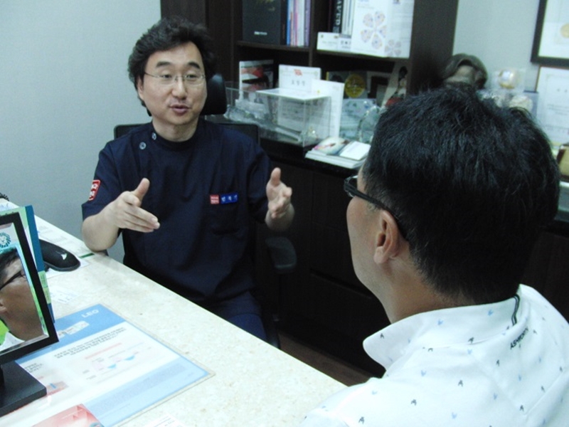 診察室で処置方法を説明するミン・ボッキ院長