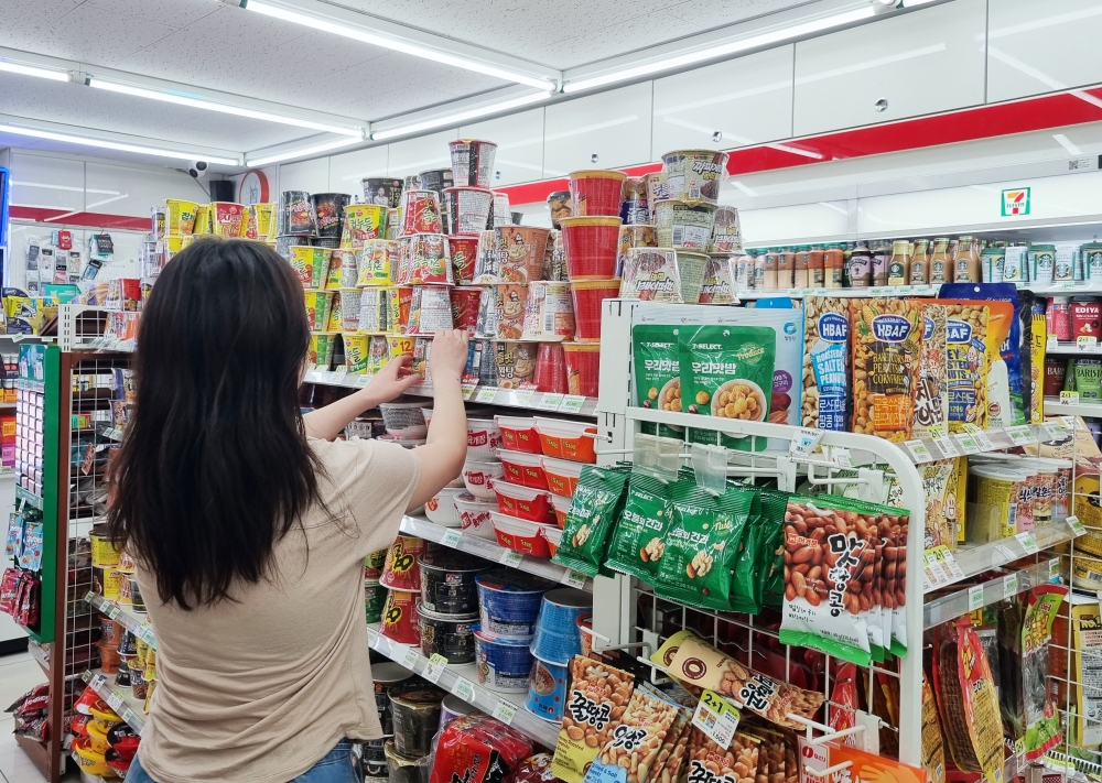 コンビニでラーメンなどの食品を手に取る消費者＝２９日、ソウル、聯合ニュース