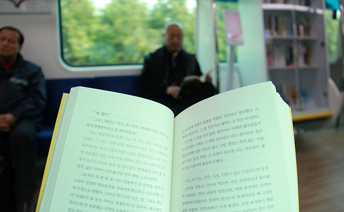 京義中央線の「読書の風列車」で本を読んでいる乗客 