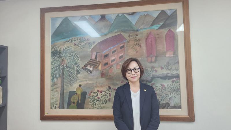 慰安婦被害者のカン・ドクギョンが描いた絵の前で記念撮影を行うイ・ナヨン理事長