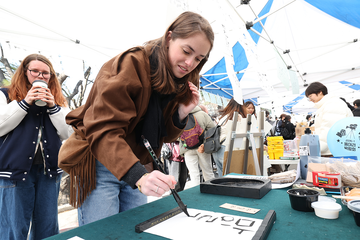 新学期を迎えた４日、京畿道水原市の亜洲（アジュ）大学で、習字を体験する外国人留学生。